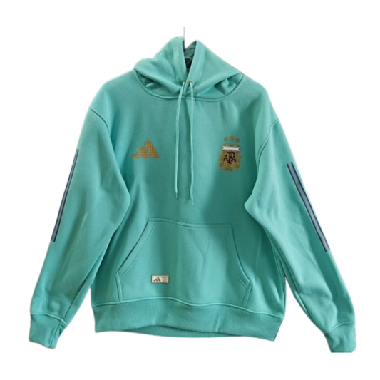 The 2026/27 Team Hoodie - Turquoise combines -inspired football identity with a comfortable everyday silhouette. The turquoise base is finished with gold details, creating a distinctive colorway for supporters.